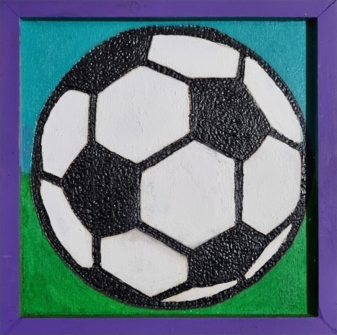 Black and white soccer ball on a colorful background.