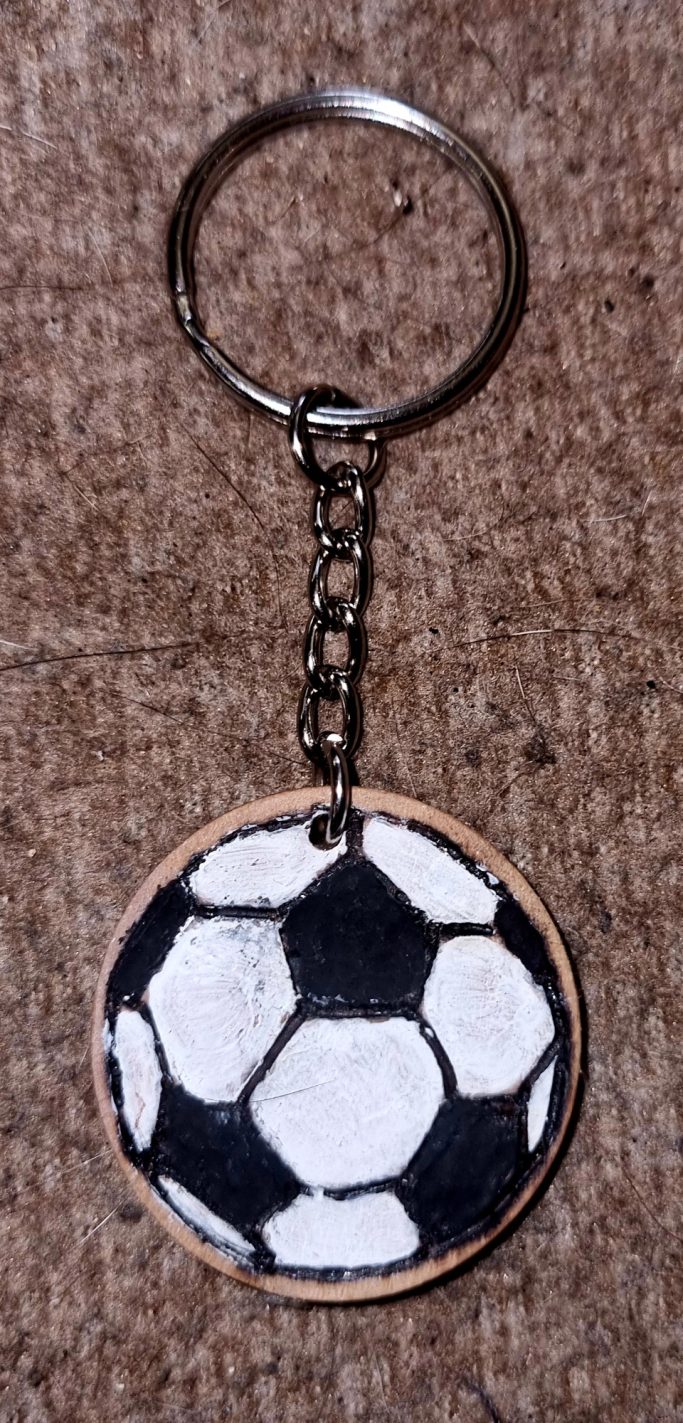 Keychain featuring a round soccer ball design in black and white.