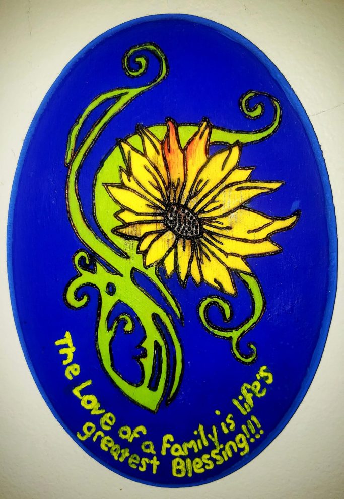 Colorful design featuring a sunflower and the text "The love of a family is life's greatest blessing."
